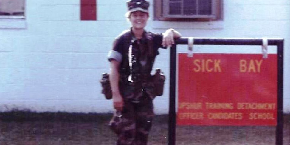 military member next to a sign