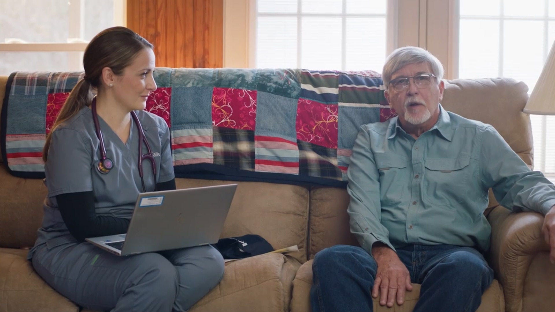 HouseCalls nurse and older adult man sitting on couch