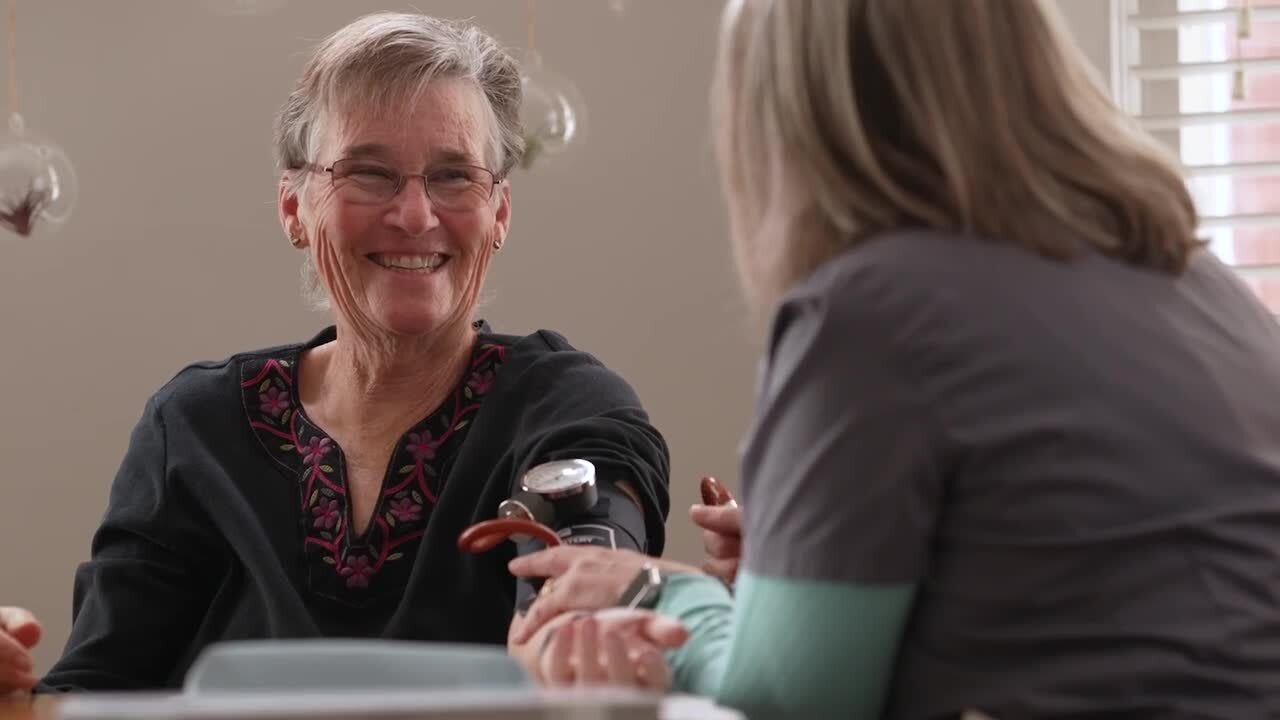 HouseCalls nurse taking blood pressure of older adult woman