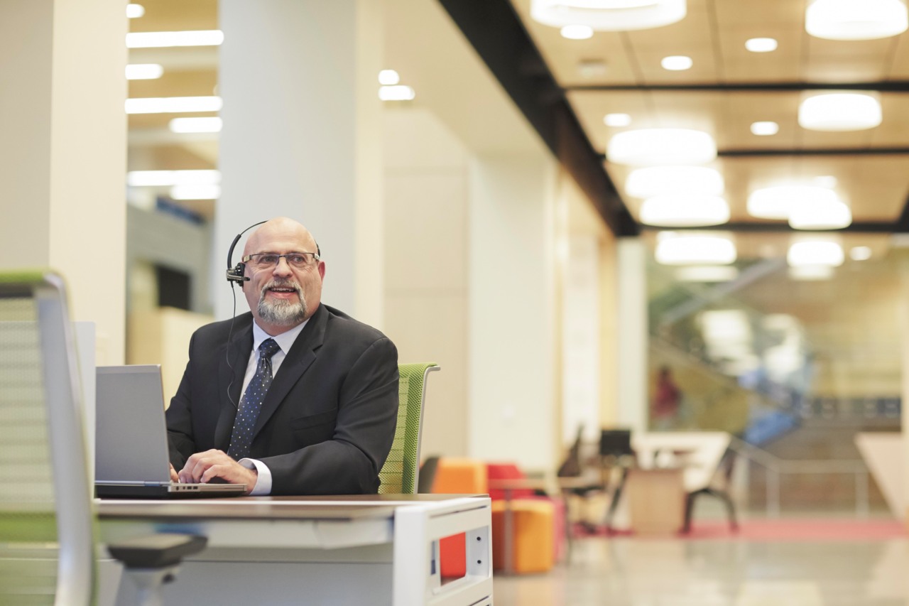 Man at desk with headset on