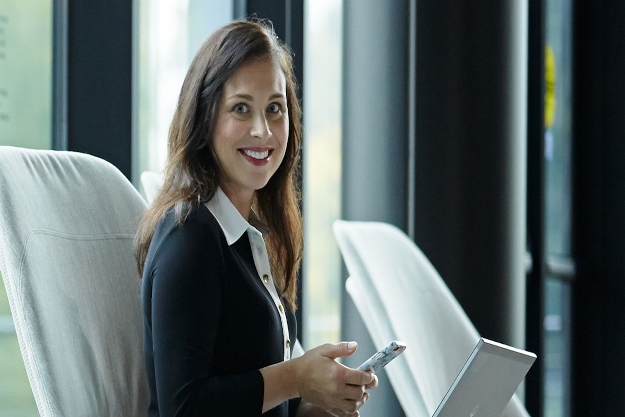 Woman with suit on using phone