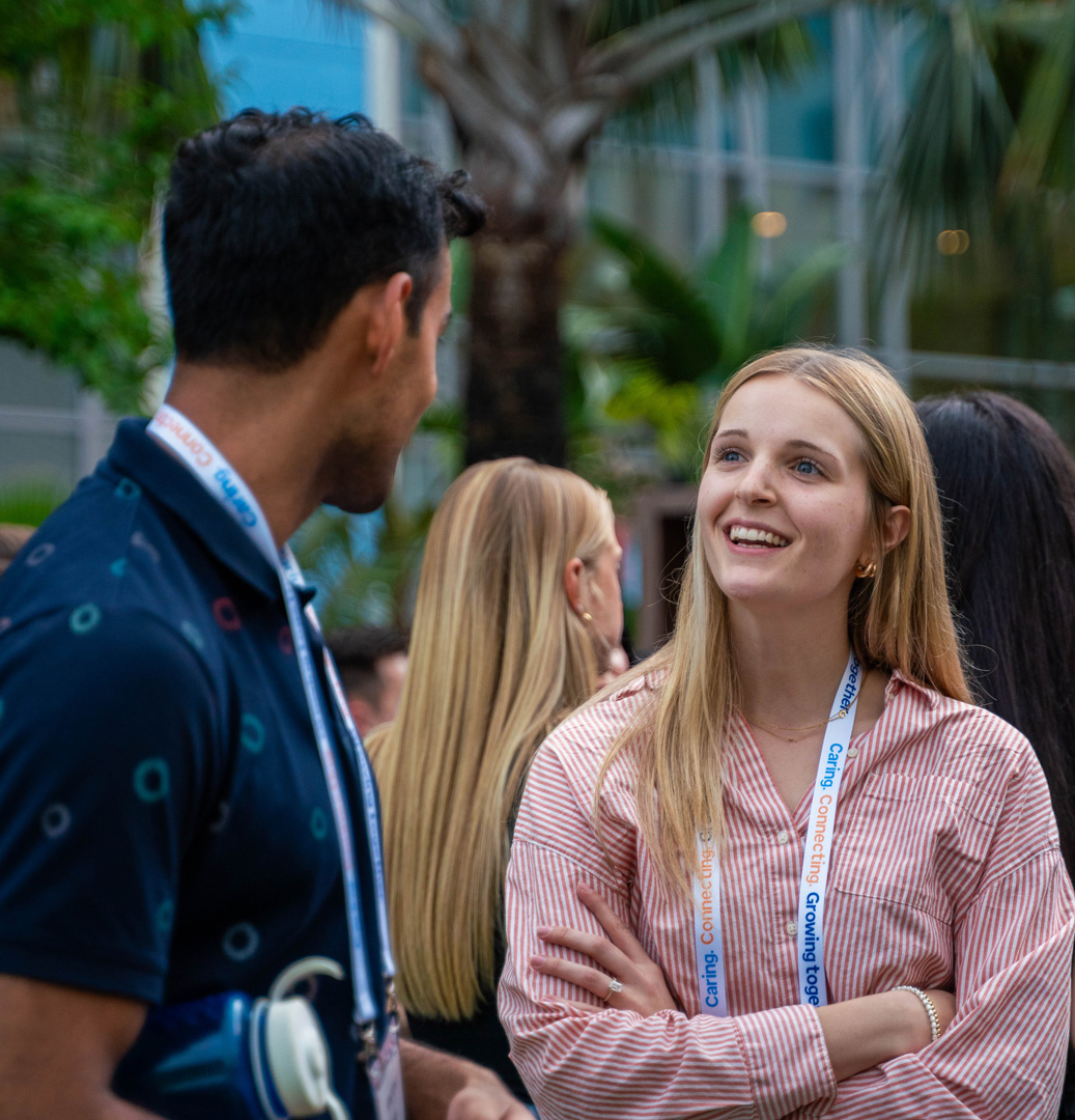 Two young adults talking in an outside environment