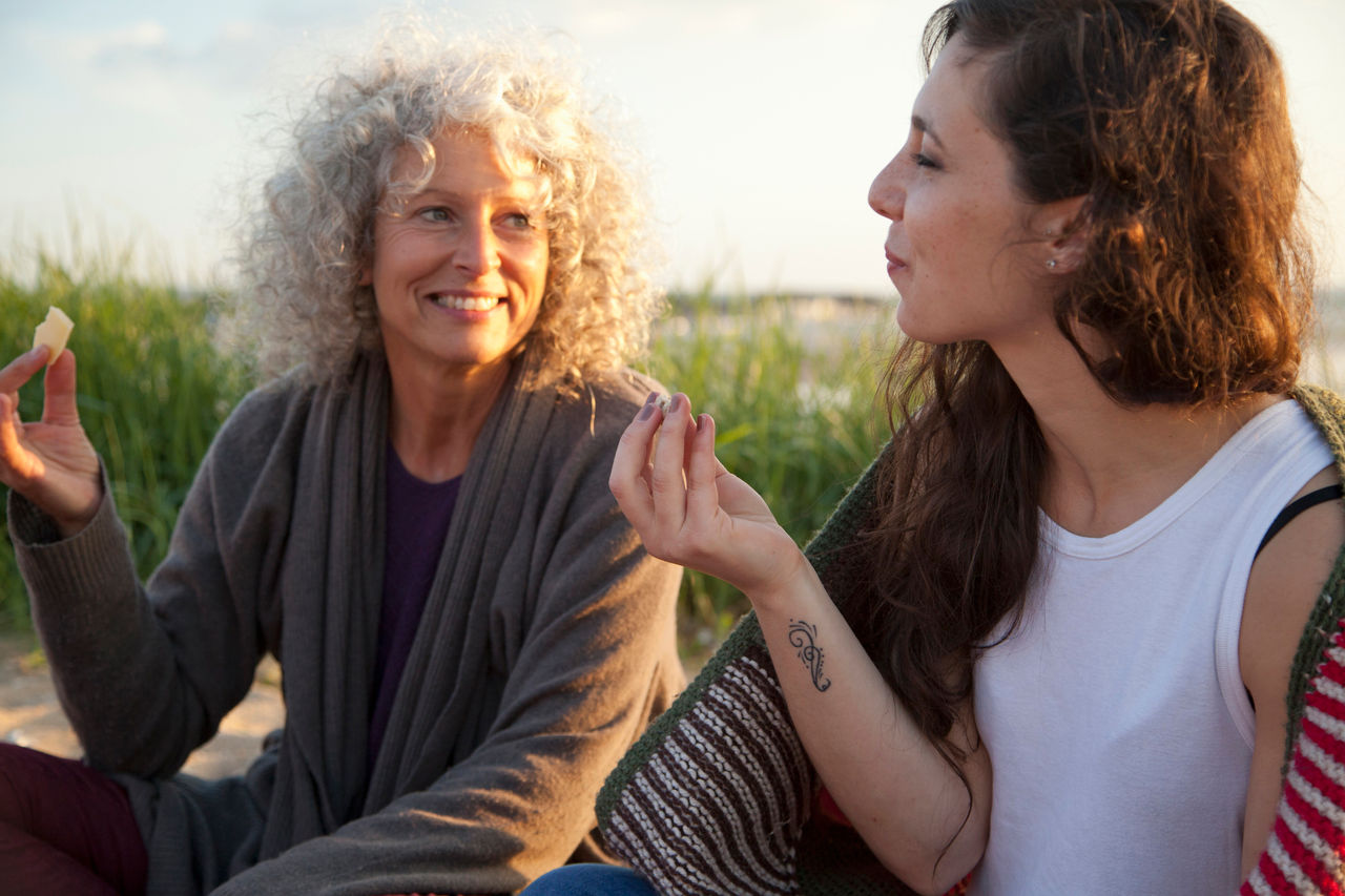 Two women having picnic on Bournemouth beach, Dorset, UK